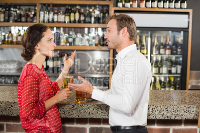 Couple arguing and holding beer