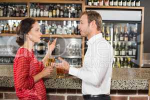 Couple arguing and holding beer