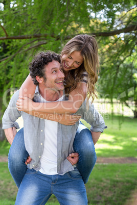 Husband giving a piggy-back to his wife