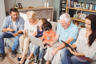 Family with grandparents using technology