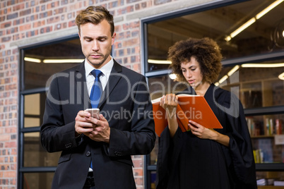 Businessman text messaging on smartphone