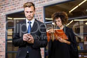 Businessman text messaging on smartphone