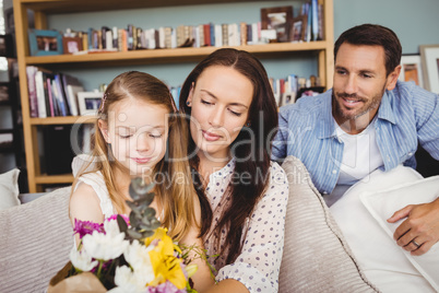 Smiling family with flower bouquet