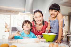 Happy woman with children preparing food at home