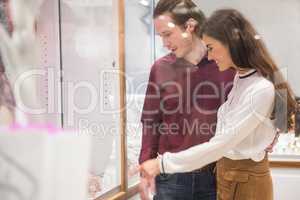 Happy couple shopping in jeweler shop