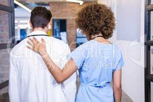 Doctor and nurse walking in hospital corridor