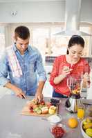 Couple preparing fruit juice