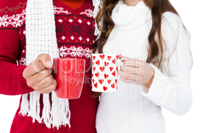 Happy couple with santa hats holding mug