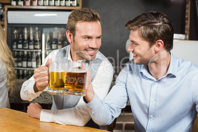 Men toasting while looking at each other