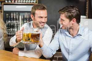 Men toasting while looking at each other