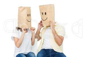 Couple covering their faces with paper bag