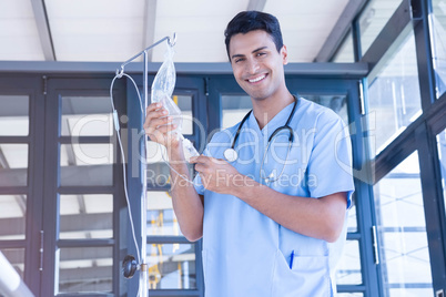Doctor holding intravenous drip