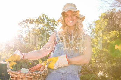 Gardener woman holding a basket of vegetables