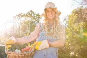 Gardener woman holding a basket of vegetables