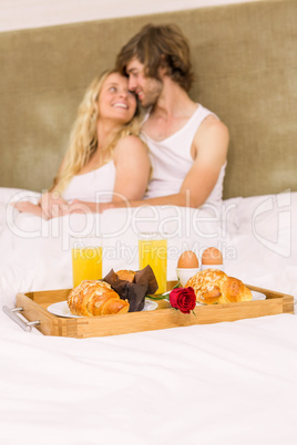 Cute couple having breakfast in bed