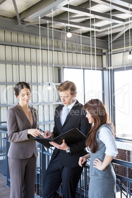 Three colleagues discussing in office