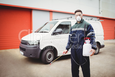 Handyman with insecticide standing