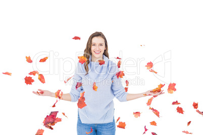 Happy woman throwing leaves