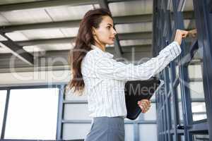 Businesswoman knocking on door