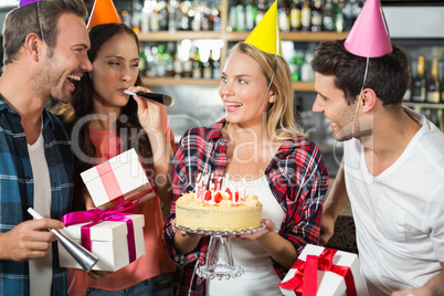 Woman smiling with cake in hands