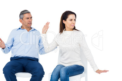 Couple arguing while sitting