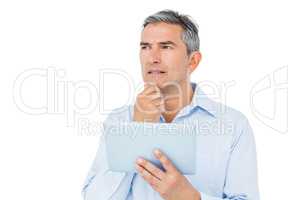 Thoughtful businessman using tablet