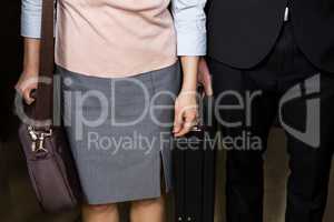 Businessman and businesswoman standing in an elevator