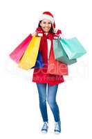 Beautiful brunette with santa hat holding shopping bags