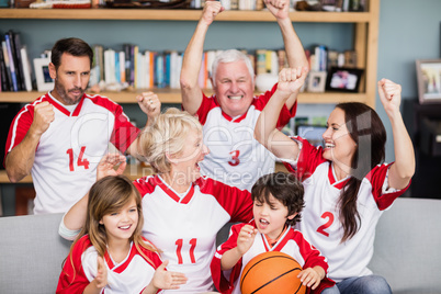 Happy family with grandparents watching basketball match