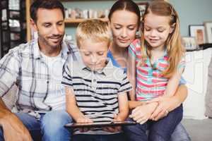 Cheerful family using technologies