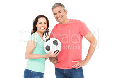 Excited football fan couple cheering at camera