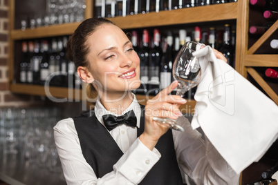 Barmaid cleaning a glass