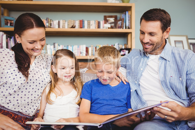 Cheerful family reading book