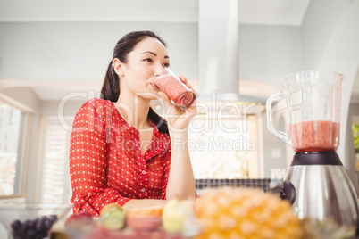 Smiling woman drinking fruit juice Smiling woman drinking fruit juice