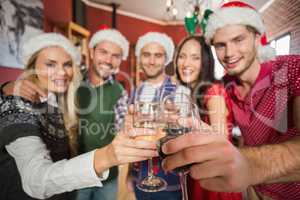 Friends wearing Christmas hats toasting