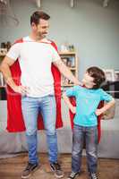 Happy father and son in superhero costume