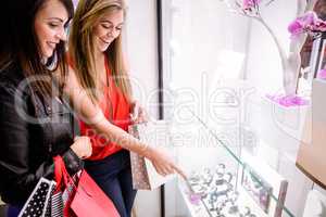 Two beautiful women selecting a wrist watch