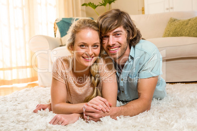 Cute couple lying on the carpet