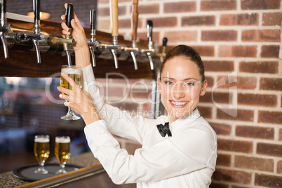 Barmaid pouring beer