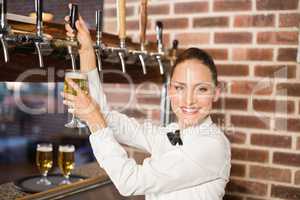 Barmaid pouring beer