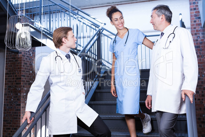Medical team interacting with each other on staircase