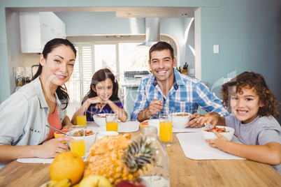 Portrait of happy family having breakfast