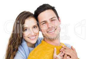 Smiling couple embracing and looking the camera