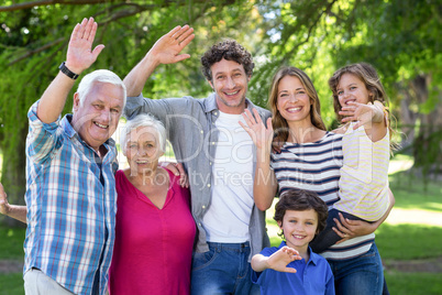 Smiling family waving hands