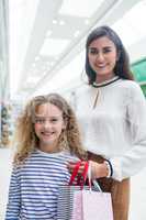 Happy mother and daughter in shopping mall