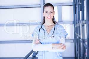 Female doctor standing with arms crossed