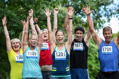 Marathon athletes posing with raised arms