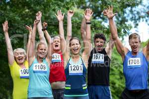 Marathon athletes posing with raised arms