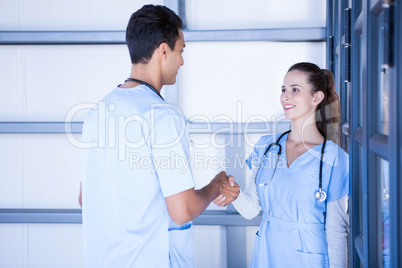 Doctors shaking hands in corridor