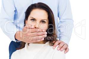 Man covering wifes mouth